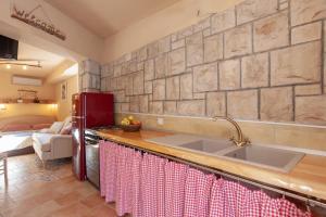 a kitchen with a sink and a brick wall at Apartments with WiFi Makarska - 6842 in Makarska