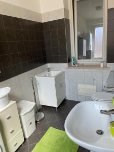a bathroom with a white sink and a mirror at Via Itria in Marsala +7 photos