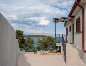 a balcony of a building with a view of the water at Vila Casa di mare Jelsa, otok Hvar in Jelsa