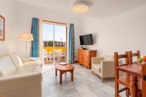 a living room with a couch and a table at Parque Santiago III Official in Playa de las Americas