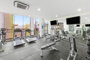 siłownia ze sprzętem do ćwiczeń wysiłkowych w budynku w obiekcie Meriton Suites Campbell Street, Sydney w mieście Sydney
