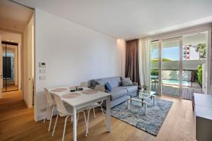 a living room with a table and a couch at Luxury Apartment Jesolo in Lido di Jesolo