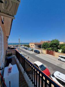 a balcony with a view of a street with parked cars at Quiet Rest in Fiumicino