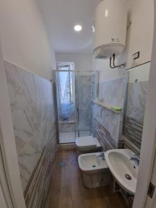 a bathroom with a shower and a sink and a toilet at Quiet Rest in Fiumicino