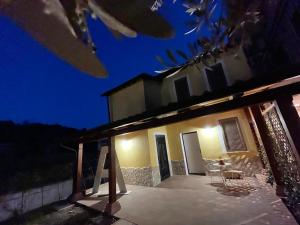 a house at night with a table and chairs at A casa di Asja in Terni +14 photos