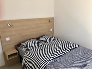 Posteľ alebo postele v izbe v ubytovaní Appartement centre ville avec piscine rooftop + 11 fotografií