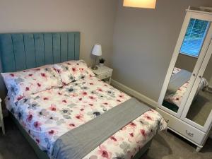a bedroom with a bed and a mirror at Beautiful private room and bathroom in Ballycastle