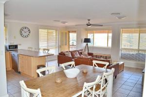 a kitchen and living room with a table and a couch at Carrington 6 in South West Rocks