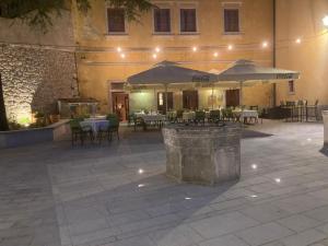 a patio with tables and umbrellas in a building at Heritage Hotel Kukuriku in Kastav