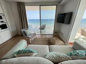 a living room with a couch and a view of the ocean at Alexandra 29 in Roses