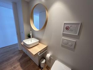 a bathroom with a sink and a mirror at Alexandra 29 in Roses +25 photos