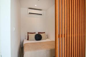 a small bedroom with a bed in a room at Phaedrus Living - Seaside Luxury Flat Harbour 105 in Paphos