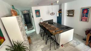 a kitchen with a island in the middle of a room at The funny Tuna in Zahara de los Atunes