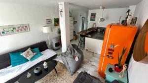 a small living room with a couch and a kitchen at The funny Tuna in Zahara de los Atunes