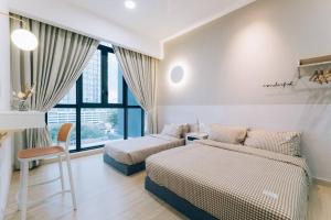 a bedroom with two beds and a window at NEW! French Style 3BR 8pax Mytown Sunway Velocity in Kuala Lumpur