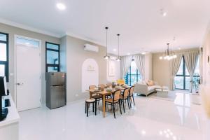 a kitchen and living room with a table and chairs at NEW! French Style 3BR 8pax Mytown Sunway Velocity in Kuala Lumpur