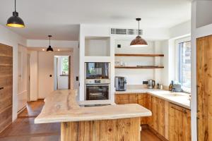 a kitchen with wooden cabinets and a counter top at Sunshine Apartment Spirit of Deer in Garmisch-Partenkirchen