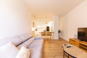a living room with a couch and a table at Bravissimo Sirenes, 2-bedroom apartment in Girona