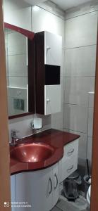 a bathroom with a red sink and a mirror at Savvas Studios in Kefalos