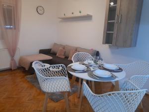 a living room with a table and chairs and a couch at Apartman Stevan in Pirot