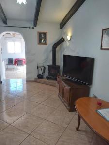 a living room with a flat screen tv and a fireplace at 2-Bed Villa with pool garden & parking near Seron in Serón