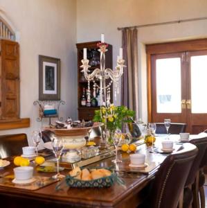 a dining room table with fruits and wine glasses on it at Antria Boutique Lodge in Blenheim