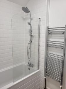 a shower with a glass door in a bathroom at The Velvet Crab in Scarborough