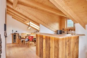 a kitchen with a wooden counter in a room with wooden ceilings at Chalet Sunshine in Garmisch-Partenkirchen
