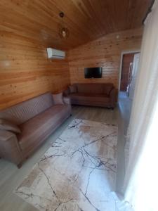 a living room with a couch and a flat screen tv at Sea garden apart in Demre