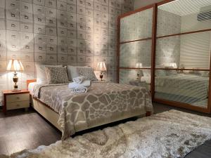 a bedroom with a bed with a teddy bear on it at Old City Lux in Baku