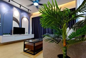 a palm tree in a lobby with a tv at Residensi Lili by James NEARBY KILA, KILA 2, PUTRAJAYA, CYBERJAYA in Nilai