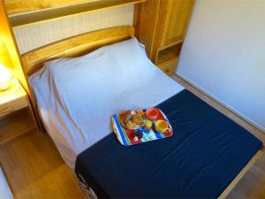 a small bed with a tray of toys on it at Appartement Bagnères-de-Luchon, 2 pièces, 4 personnes - FR-1-313-123 in Luchon