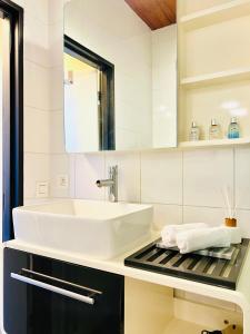 a white bathroom with a sink and a mirror at Riverview Studio in Historical Heart of Antwerp in Antwerp