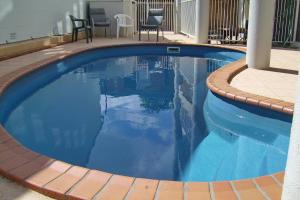 a swimming pool with blue water in a house at Jubilee Apartment 14 in South West Rocks