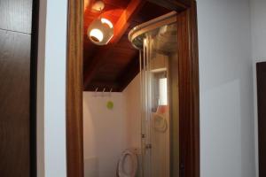 a bathroom with a toilet and a light on the ceiling at Zef's Cottage in São Vicente