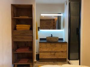 a bathroom with a sink and a mirror at les jardins de val in Val-d'Isère