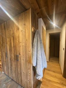 a wooden room with a towel hanging on the wall at les jardins de val in Val dʼIsère