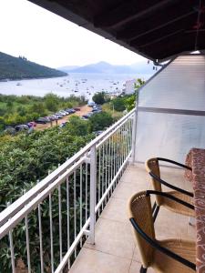 a balcony with chairs and a view of the water at Apartments Rade Bigovo in Tivat