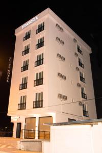 a large white building at night at Fidanoğlu Suite Hotel Çorlu in Corlu