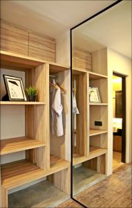 a room with a shelf with a mirror and bookshelves at U Hotel Penang in Bayan Lepas