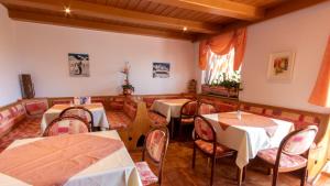 a restaurant with tables and chairs in a room at Café Pension Alpina in Innsbruck