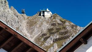 a building on the side of a mountain at Café Pension Alpina in Innsbruck