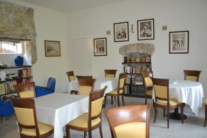 a dining room with tables and chairs and a fireplace at Villa La Cucullera in Catanzaro