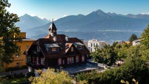 a large building with a tower on top of a city at Café Pension Alpina in Innsbruck