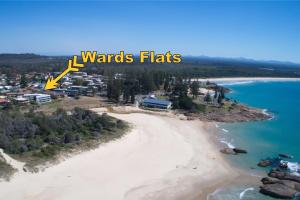 an aerial view of a beach with the words wizards flats at Wards Holiday Flat 3 in South West Rocks
