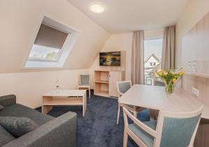 a living room with a couch and a table at Haus Schwalbe mit Vineta Komfort Häusern in Zempin