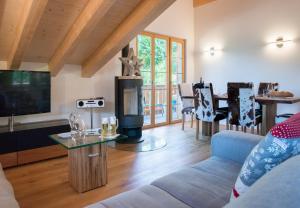 a living room with a couch and a flat screen tv at Panoramapark Soleil Chalet E in Wengen