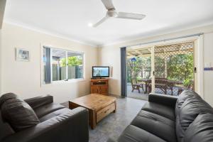 a living room with a couch and a table at PJ's Cottage - Bring your own linen. in South West Rocks