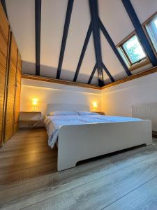 a bedroom with a large white bed in a attic at Ferienhaus Odenwald in Michelstadt