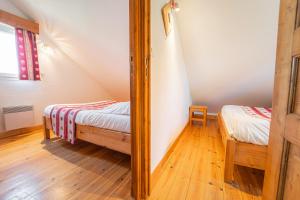 um quarto com 2 camas num sótão em Village de gîtes Les Chalets de l'Aubrac em Aumont-Aubrac